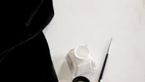 white ink and paint brush and black velvet by hanli