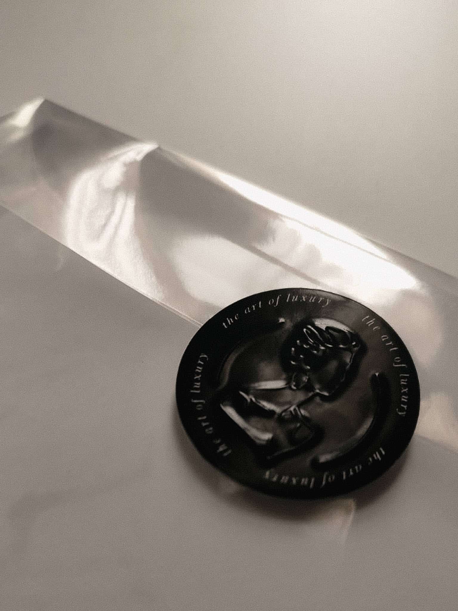 Live Event sketches are packaged in a plastic sleeve and sealed with an embossed sticker with the BY HANLI logo. Details of a live event artist and fashion illustrator.